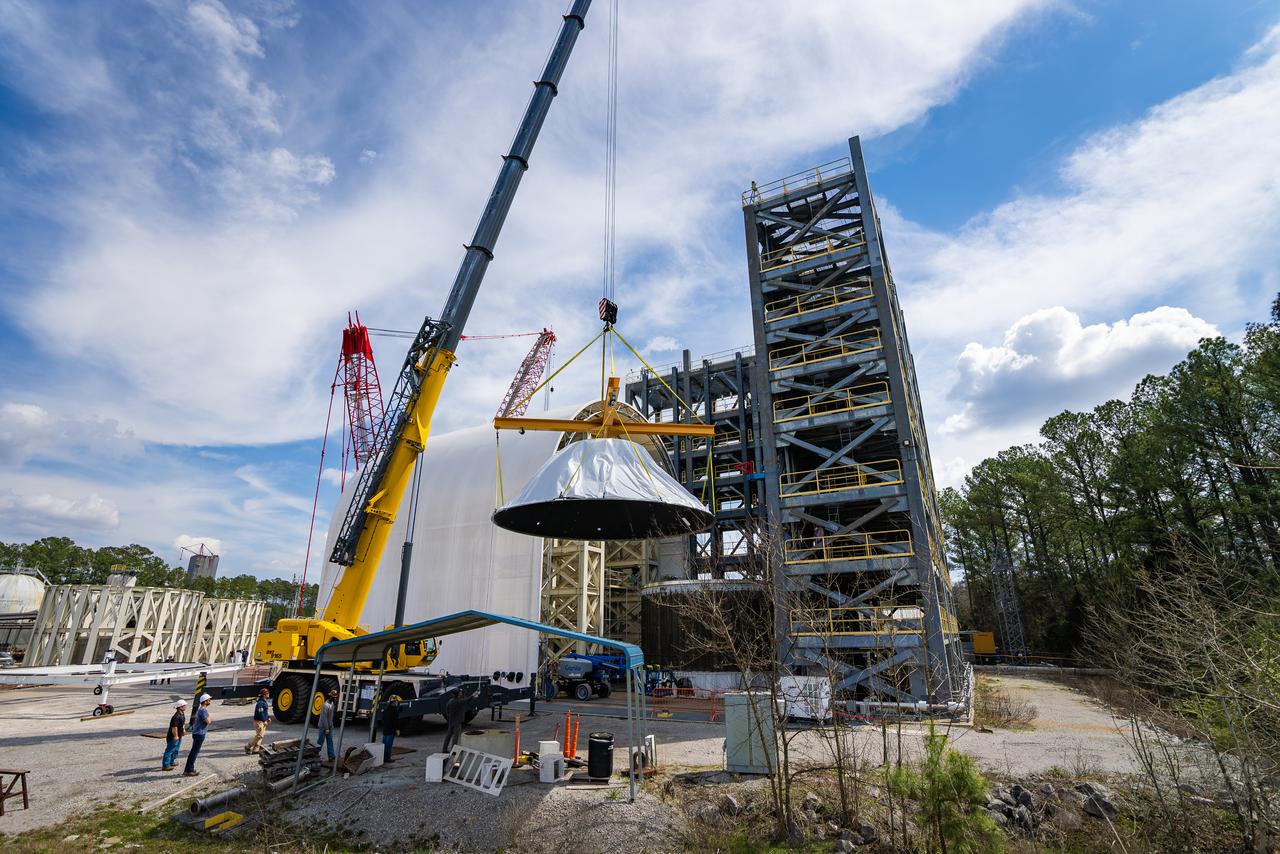 These photos and videos show how crews at NASA’s Marshall Space Flight Center in Huntsville, Alabama, moved and installed the payload adapter that will be used in the Block 1B configuration of the SLS (Space Launch System) rocket from Building 4708, where it was manufactured, into Structural Test Stand 4697 at NASA’s Marshall Space Flight Center on March 13. Teams at Marshall will begin structural testing the engineering development unit of the payload adapter – an exact replica of the flight version of the hardware – this spring. The cone-shaped payload adapter is about 8.5 feet tall and features two metal rings and eight composite panels. The adapter, which will debut on NASA’s Artemis IV mission, is an evolution from the Orion stage adapter used in the Block 1 configuration of the first three Artemis missions. It will be housed inside the universal stage adapter atop the rocket’s more powerful in-space stage, called the exploration upper stage. The payload adapter, like the launch vehicle stage adapter and the Orion stage adapter, is fully manufactured and tested at Marshall, which manages the SLS Program. NASA is working to land the first woman, first person of color, and its first international partner astronaut on the Moon under Artemis. SLS is part of NASA’s backbone for deep space exploration, along with the Orion spacecraft and Gateway in orbit around the Moon and commercial human landing systems, next-generational spacesuits, and rovers on the lunar surface. SLS is the only rocket that can send Orion, astronauts, and supplies to the Moon in a single launch.